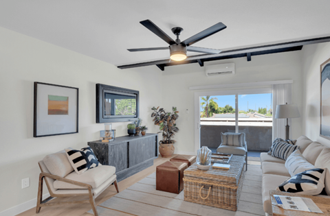 a living room with a couch and a ceiling fan